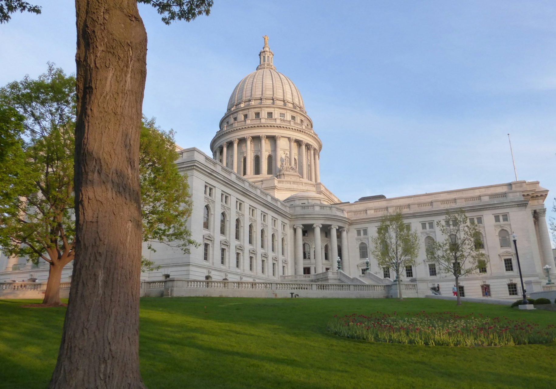 Wisconsin state capitol. Photo by <a href="https://unsplash.com/@jlm?utm_source=unsplash&utm_medium=referral&utm_content=creditCopyText">John Murray</a> on <a href="https://unsplash.com/photos/a-large-white-building-with-a-dome-with-wisconsin-state-capitol-in-the-background-Z2F6mjc_ouU?utm_source=unsplash&utm_medium=referral&utm_content=creditCopyText">Unsplash</a>
      